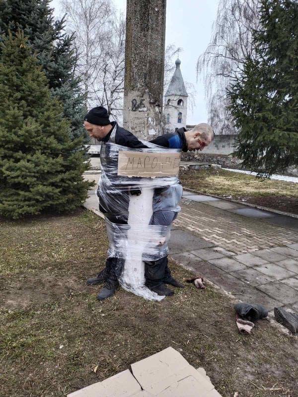 PHOTOS: Citizens Of Kyiv Duct Tape Highway Robbers To Lamp Posts In Winter