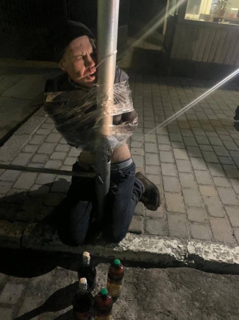 PHOTOS: Citizens Of Kyiv Duct Tape Highway Robbers To Lamp Posts In Winter
