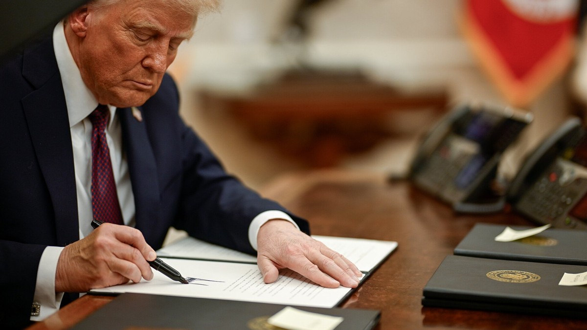 President Trump signing an executive order at his desk